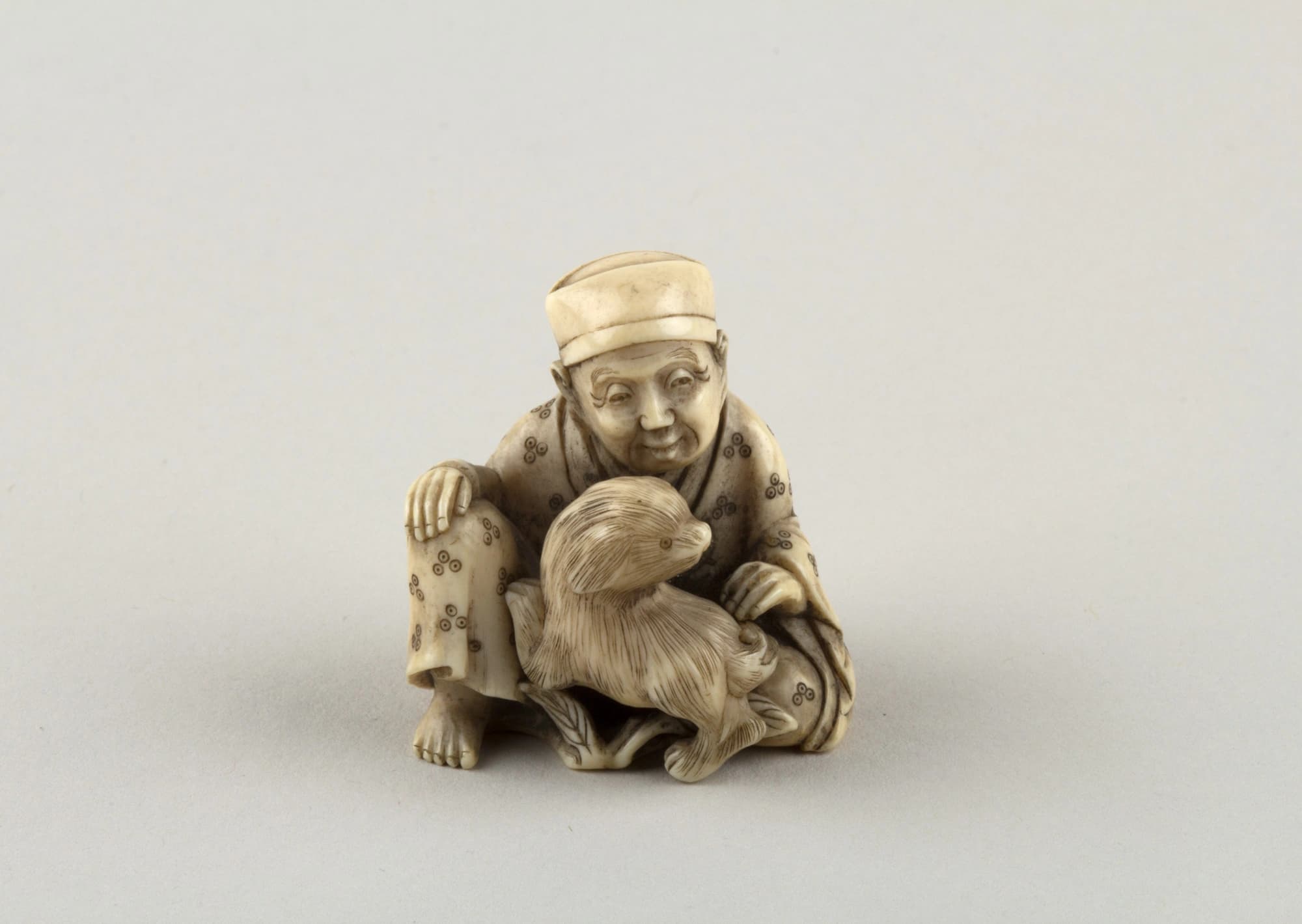 Seated figure of a Man with Dog